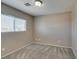 Cozy bedroom featuring neutral walls, carpeted floor, and a bright window at 3396 Villa Fiori Ave, Las Vegas, NV 89141