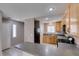 Functional kitchen features wood cabinets, gas range, and breakfast bar seating at 3396 Villa Fiori Ave, Las Vegas, NV 89141