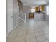 Inviting living room boasts tile flooring, open layout to kitchen, and staircase access at 3396 Villa Fiori Ave, Las Vegas, NV 89141