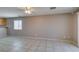 Neutral living room with tile flooring, fan and window, ready for personalization at 3396 Villa Fiori Ave, Las Vegas, NV 89141