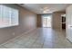 Large living room with neutral paint, tile flooring, sliding glass door and lots of natural light at 3396 Villa Fiori Ave, Las Vegas, NV 89141