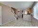 Comfortable living area showcases tile floor, staircase, and view of the kitchen at 3396 Villa Fiori Ave, Las Vegas, NV 89141