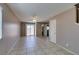 Spacious living room with tile floors, sliding glass door, neutral paint and open floorplan at 3396 Villa Fiori Ave, Las Vegas, NV 89141