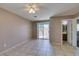 Spacious living room with neutral paint, tile flooring, ceiling fan and sliding glass door at 3396 Villa Fiori Ave, Las Vegas, NV 89141