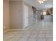 Spacious living area with tile flooring, connecting seamlessly to the kitchen and staircase at 3396 Villa Fiori Ave, Las Vegas, NV 89141