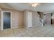 Bright living room with tile flooring, staircase, multiple entrances, and kitchen view at 3396 Villa Fiori Ave, Las Vegas, NV 89141