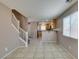 Open living space features staircase and tile flooring leading into kitchen area at 3396 Villa Fiori Ave, Las Vegas, NV 89141