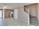 Large living room with neutral paint, tile flooring, sliding glass door and staircase at 3396 Villa Fiori Ave, Las Vegas, NV 89141