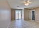 Spacious living room with neutral paint, tile flooring, ceiling fan and sliding glass door at 3396 Villa Fiori Ave, Las Vegas, NV 89141