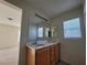 Bathroom with double vanity and large mirror at 4202 Mango Tree Ct, Las Vegas, NV 89115