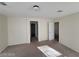 Spacious bedroom with carpet and access to bathroom and another room at 4202 Mango Tree Ct, Las Vegas, NV 89115