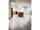 Kitchen with island and pantry, gray vinyl plank flooring at 4202 Mango Tree Ct, Las Vegas, NV 89115