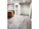 Kitchen with island and pantry, gray vinyl plank flooring at 4202 Mango Tree Ct, Las Vegas, NV 89115