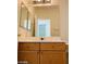 Clean bathroom with wood vanity and mirrored medicine cabinet at 43 Pangloss St, Henderson, NV 89002