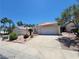 House exterior featuring a two-car garage and desert landscaping at 43 Pangloss St, Henderson, NV 89002