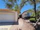 Side view of the house showing garage and walkway at 43 Pangloss St, Henderson, NV 89002