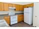 Well-equipped kitchen with white appliances and wood cabinets at 43 Pangloss St, Henderson, NV 89002