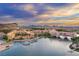 Aerial view of a luxury community on a lake at sunset at 52 Reverie Heights Ave, Henderson, NV 89011