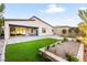Landscaped backyard with artificial turf and patio at 52 Reverie Heights Ave, Henderson, NV 89011