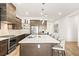 Contemporary kitchen featuring a large island and stainless steel appliances at 52 Reverie Heights Ave, Henderson, NV 89011