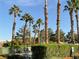 Community pool with palm trees and lush landscaping at 5400 Paul Kurtz Way # 102, Las Vegas, NV 89108