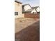 Backyard with gravel and adjacent houses at 5987 Stone Hollow Ave, Las Vegas, NV 89156