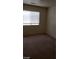 Spacious bedroom with window and carpeted floor at 5987 Stone Hollow Ave, Las Vegas, NV 89156