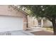 Two-story house with a two-car garage and walkway to the entrance at 5987 Stone Hollow Ave, Las Vegas, NV 89156