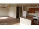 Open floor plan with kitchen island, dining area, and carpet at 5987 Stone Hollow Ave, Las Vegas, NV 89156