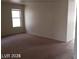 Bright living room with large window and carpeted floors at 5987 Stone Hollow Ave, Las Vegas, NV 89156