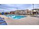 Community pool with lounge chairs and umbrellas at 600 N Carriage Hill Dr # 1108, Las Vegas, NV 89138