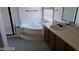 Bathroom boasts a large tub, sink, and glass shower at 6684 Coronado Crest Ave, Las Vegas, NV 89139