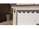 White two-car garage with opener and address number visible at 6684 Coronado Crest Ave, Las Vegas, NV 89139