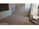 Spacious living room with neutral carpet and a staircase at 6684 Coronado Crest Ave, Las Vegas, NV 89139