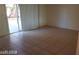 Spacious living room with tile floors and sliding door to patio at 6684 Coronado Crest Ave, Las Vegas, NV 89139