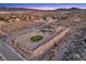 Expansive lot featuring a putting green, pool, covered patio, and a two-story home with a desert landscape at 12745 Fairfield Ave, Henderson, NV 89044