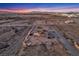 Desert home on a large lot with a putting green and swimming pool overlooks a desert landscape and city lights at 12745 Fairfield Ave, Henderson, NV 89044