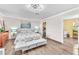 Spacious bedroom featuring laminate floors, neutral paint, and natural light from large windows at 12745 Fairfield Ave, Henderson, NV 89044