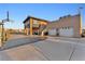 Two-story home featuring a large driveway, basketball hoop, well-kept landscaping, and a two-door garage at 12745 Fairfield Ave, Henderson, NV 89044