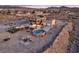 Aerial view of a two-story home with a pool, patio, playground, and unique desert landscaping elements at 12745 Fairfield Ave, Henderson, NV 89044