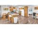 Open kitchen with a breakfast bar, dining area, white appliances, hardwood floors, and ample counter space at 12745 Fairfield Ave, Henderson, NV 89044