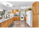 Bright kitchen featuring wood cabinets, white appliances, and marble countertops offers a cozy cooking space at 12745 Fairfield Ave, Henderson, NV 89044