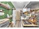 Efficient kitchen with modern appliances, a faux green wall, and stylish shelving at 12745 Fairfield Ave, Henderson, NV 89044