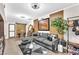 Living room featuring laminate floors, accent wall, sliding barn doors, and comfortable seating at 12745 Fairfield Ave, Henderson, NV 89044
