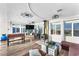 Open living space featuring hardwood floors, large windows, a wood-burning stove, and a comfortable seating area at 12745 Fairfield Ave, Henderson, NV 89044