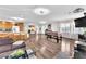 Open living space with hardwood floors, a foosball table, natural lighting, and open to the kitchen at 12745 Fairfield Ave, Henderson, NV 89044