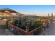 Outdoor playground with swings, seating, and covered area for entertaining features mountain views in the distance at 12745 Fairfield Ave, Henderson, NV 89044
