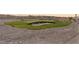 Landscaped backyard putting green features synthetic turf and a sand trap area for practice at 12745 Fairfield Ave, Henderson, NV 89044