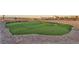 Backyard putting green with artificial turf and sand trap features unique landscaping elements and desert landscaping at 12745 Fairfield Ave, Henderson, NV 89044