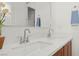 Bright bathroom featuring double sinks, quartz countertops, modern faucets and towel racks at 177 Cactus Sunrise St, Las Vegas, NV 89138